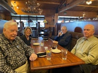 a group of people sitting at a table in a restaurant