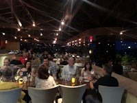 a group of people eating at a restaurant