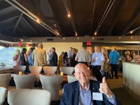 a man giving a thumbs up in a restaurant