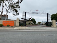 a gated entrance to a building with an airplane on it