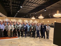 a large group of people standing in a room