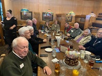 a group of people sitting around a table