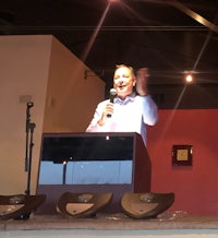 a man giving a speech at a podium