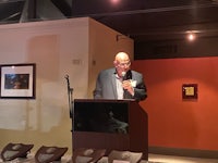 a man giving a speech at a podium