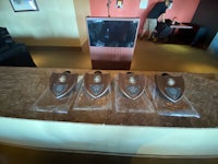 four trophies on a table in front of a television